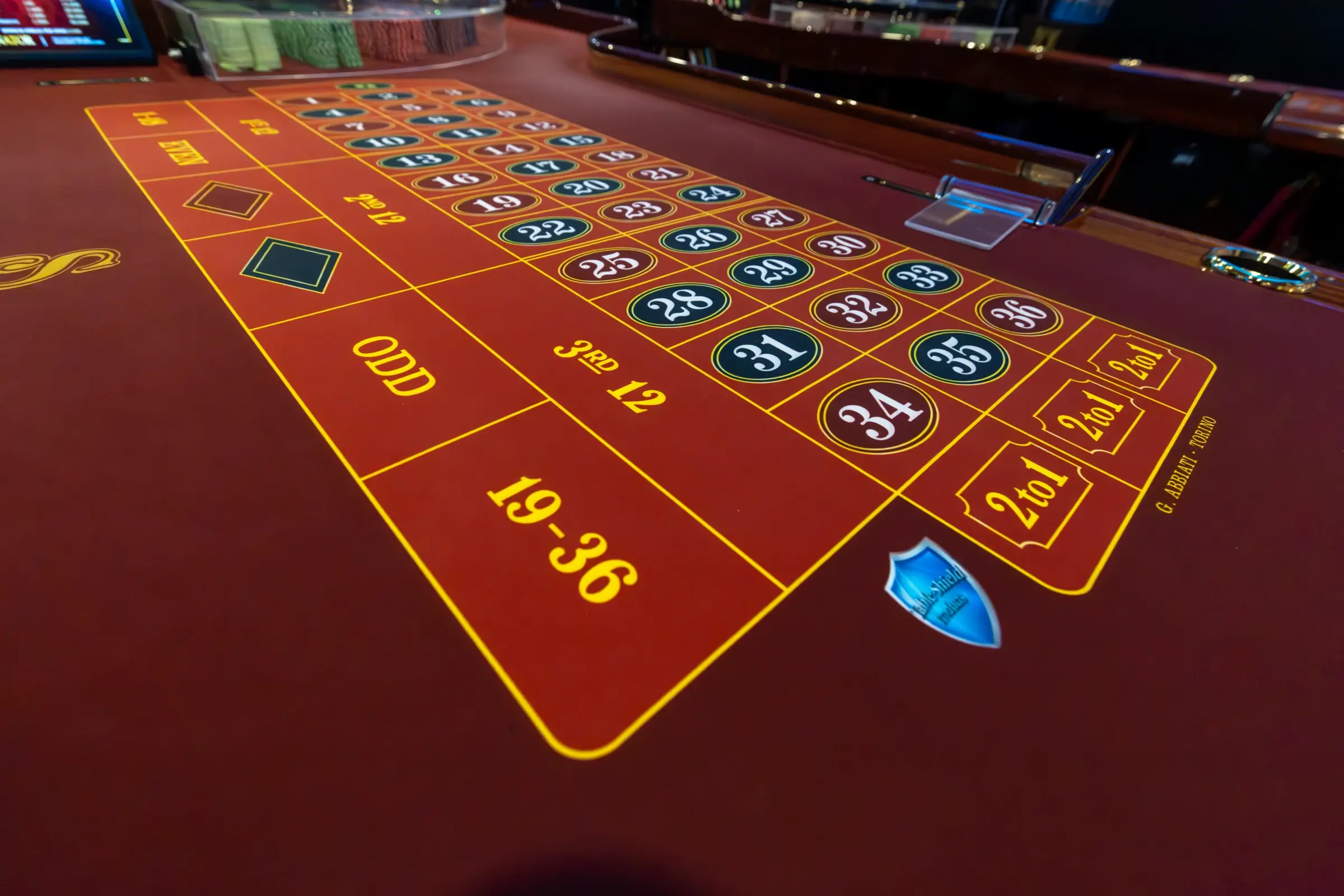 The red betting layout of a roulette table, numbers and outside bets picked out in gold, Guatemala