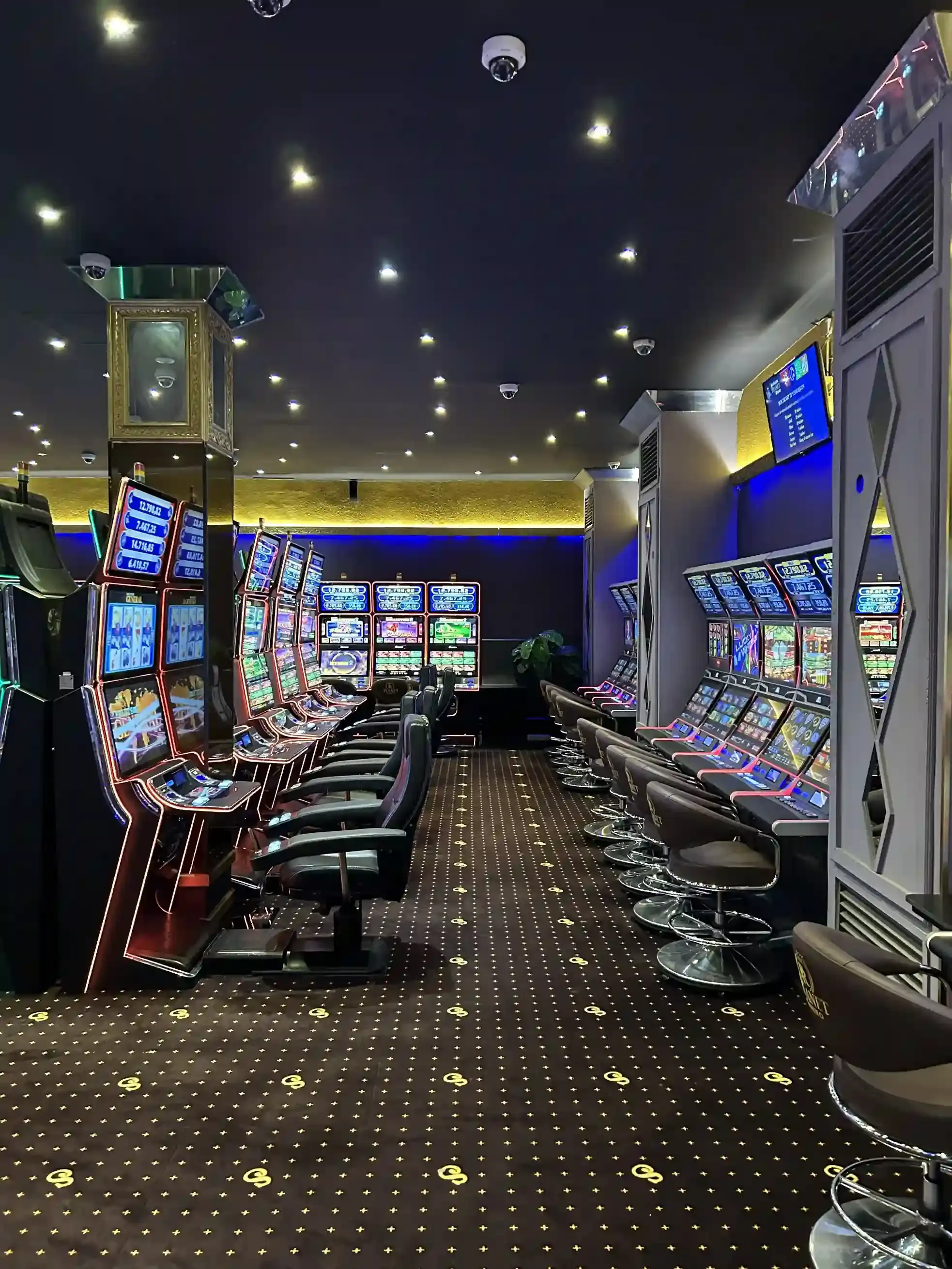 Two facing rows of slot machines at Planet Casino